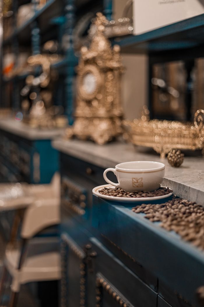 Home Elegant coffee cup sitting on counter in vintage, luxurious cafe interior.