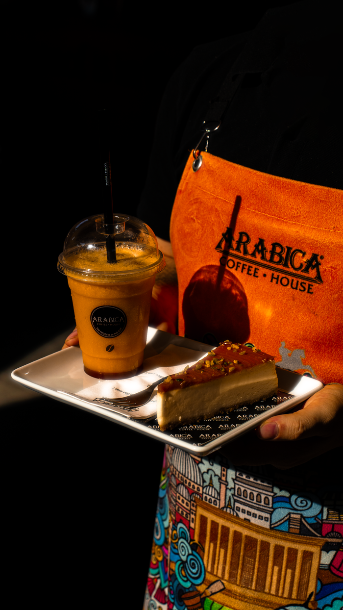 Home Enjoy a refreshing iced coffee and slice of cake at Arabica Coffee House.