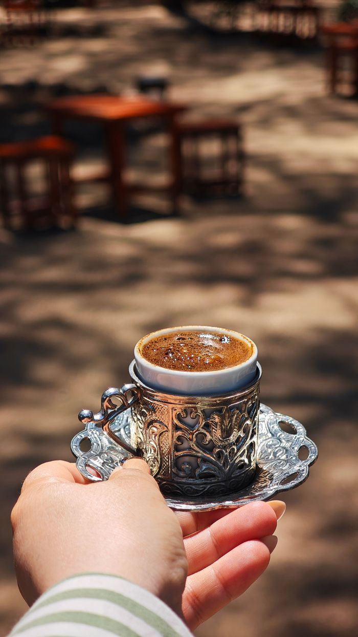 Services Enjoy a rich Turkish coffee served in an ornate cup with an outdoor ambiance.